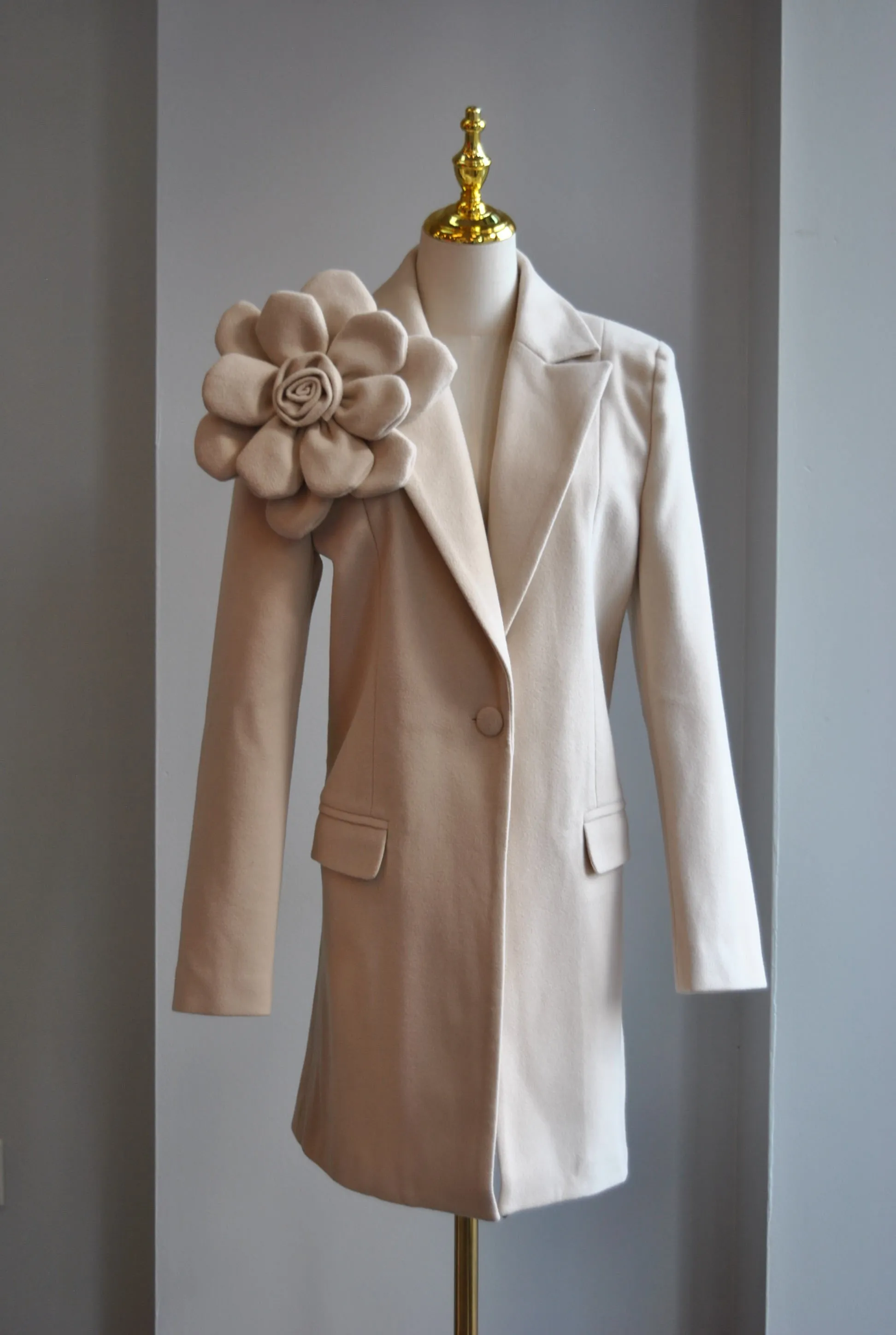 LIGHT BEIGE SPRING COAT WITH A FLOWER